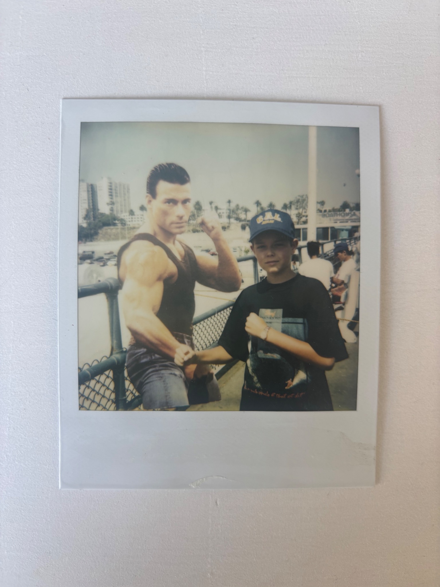 A childhood Polaroid of Pierre posing beside an action-movie figure